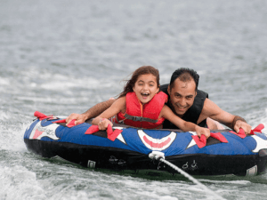 Father and daughter having fun rafting