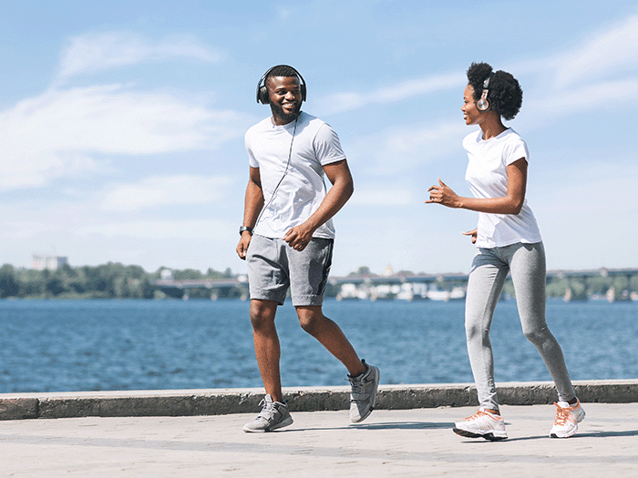 Two joggers smiling at each other