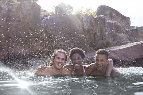 A diverse group of individuals smiling in the river