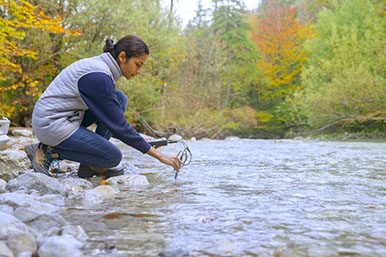 A biologist testing the oxygen levels in the river