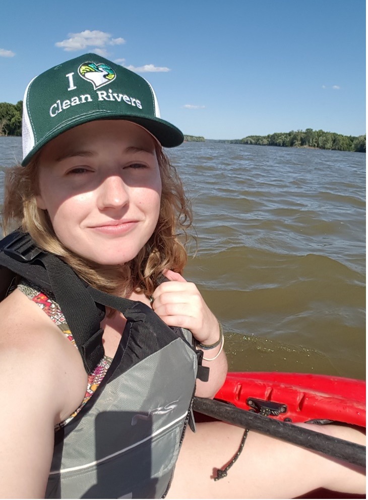 Selfie of Annie wearing an I <3 Clean Rivers hat