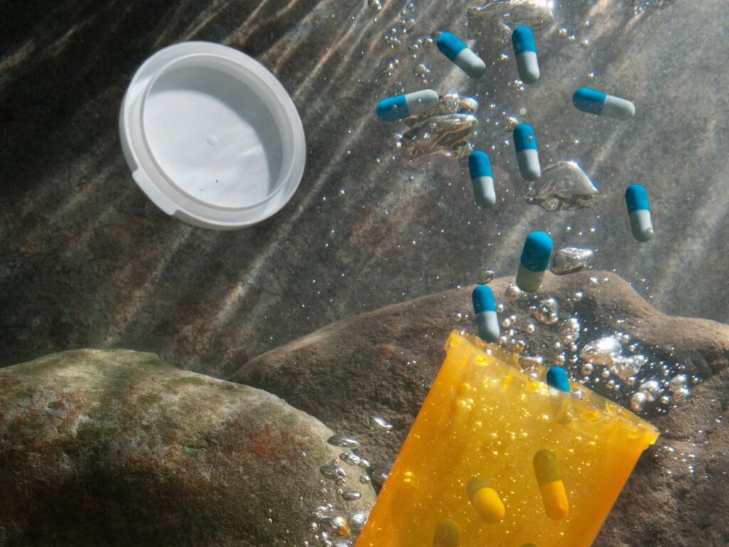 A bottle of pills underwater.