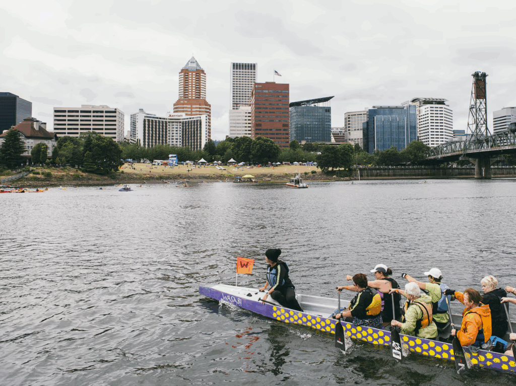 People paddling along Willamette River looking at downtown Portland